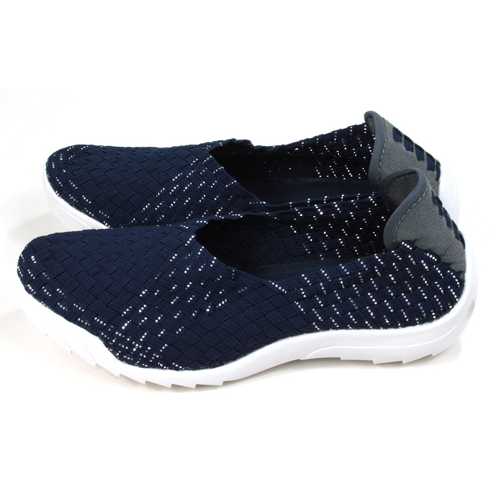 Navy blue woven fabric shoes with white rubber soles. Side view.