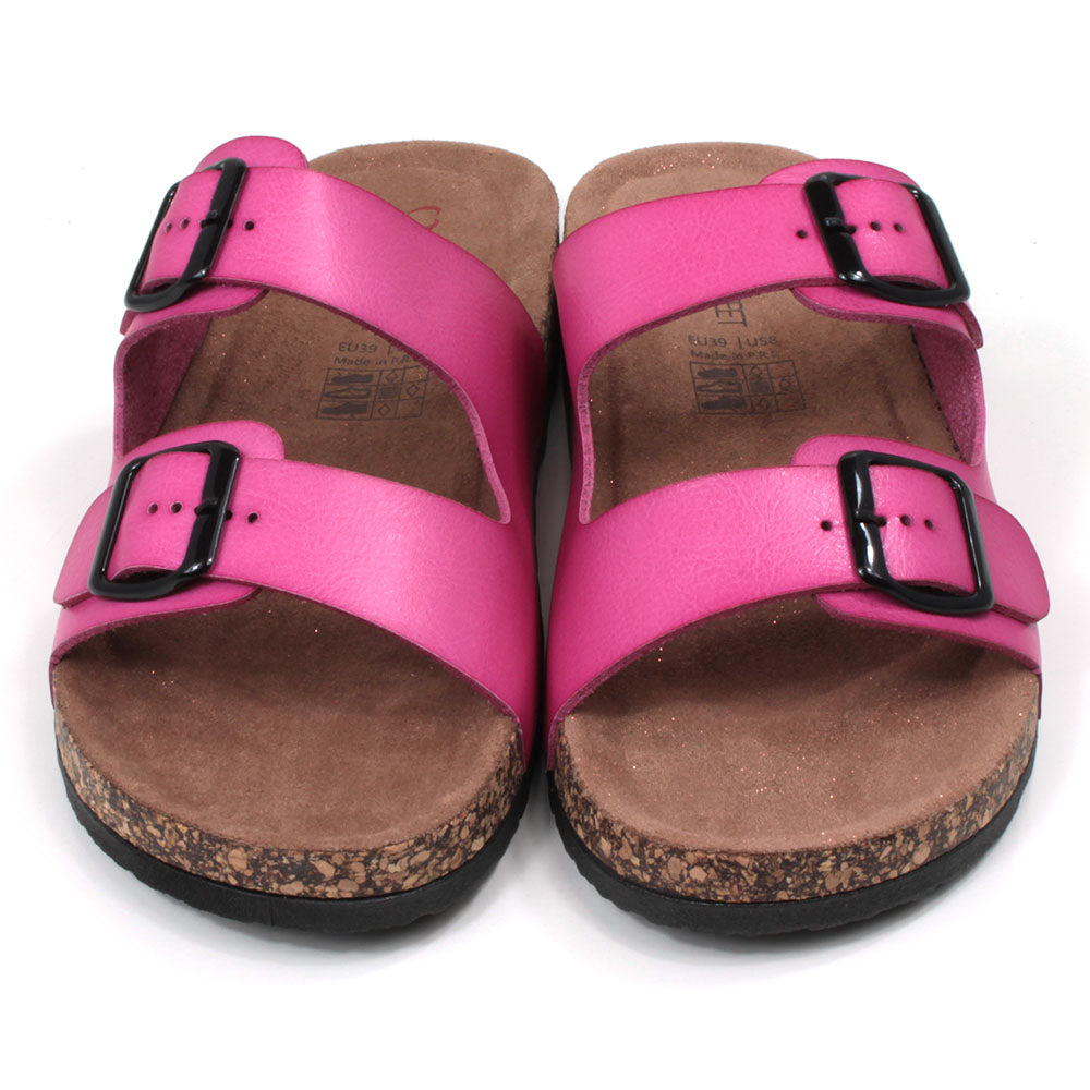 Pink double strap fuchsia pink sandals from Heavenly Feet. Backless, adjustment is with two black buckles. Cork effect sculpted footbeds with pink glitter sprinkled along the floor. Front view.