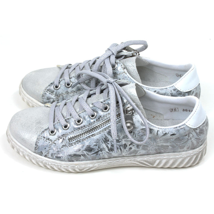 Rieker trainers in silver floral pattern. Lace up adjustment and zip fitting. Side view.