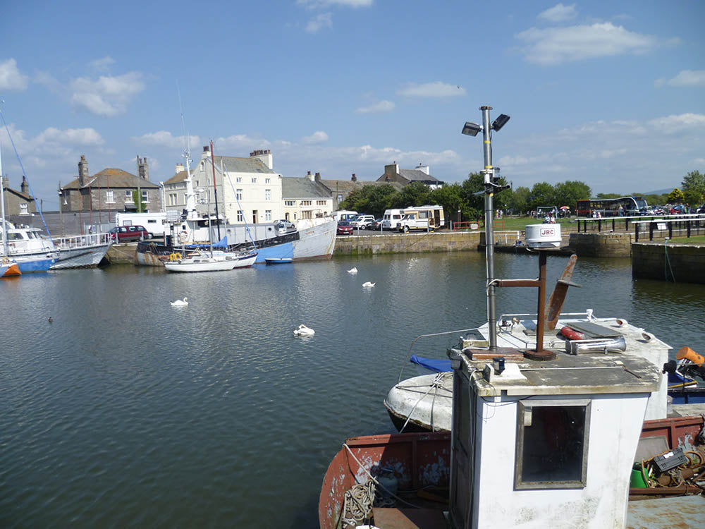 View of Glasson Dock with boats and buildings on the far side