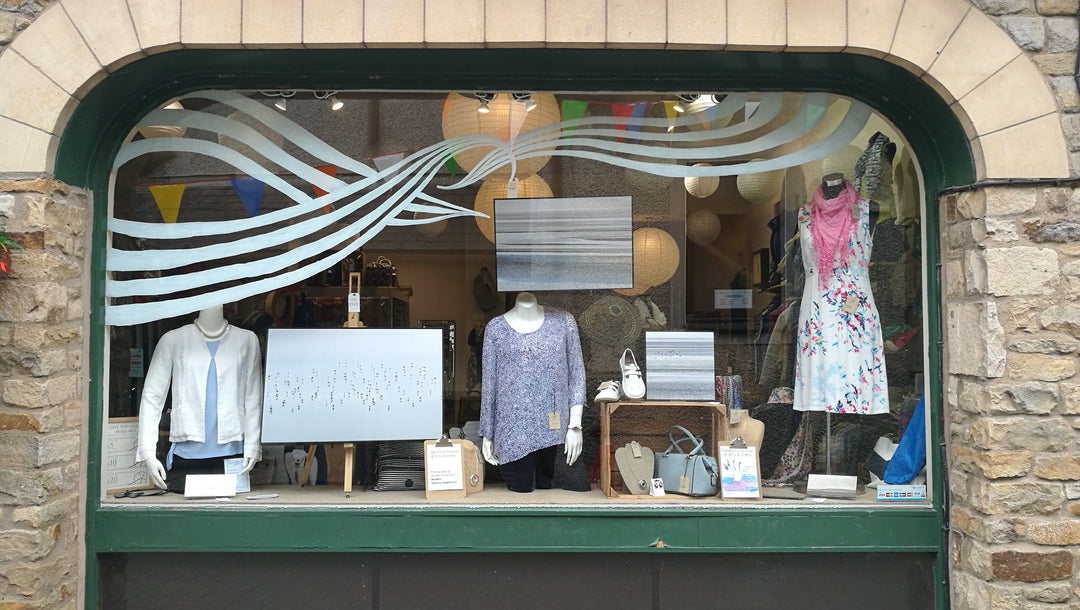 Kitty Brown Boutique window with white waves window painting