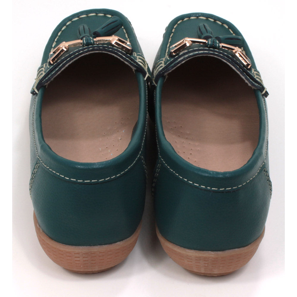 Joe and Jo moccasin style slip on, leather shoes in jasper green colour. Over the foot metallic gold coloured  detail and two matching tassels. Beige rubber soles. Back view.