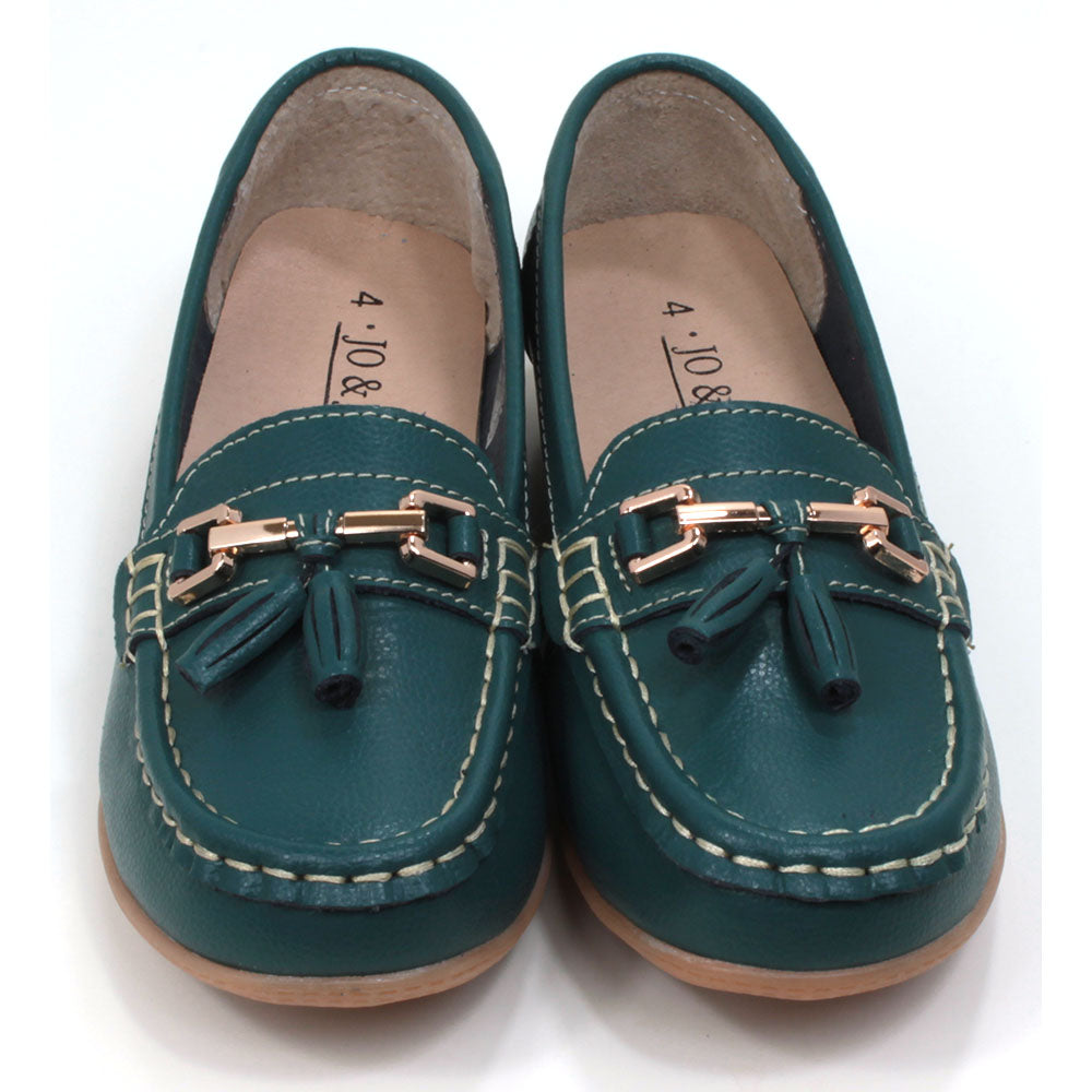 Joe and Jo moccasin style slip on, leather shoes in jasper green colour. Over the foot metallic gold coloured  detail and two matching tassels. Beige rubber soles. Front view.