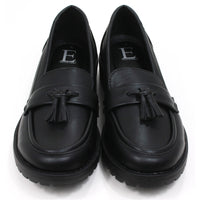 Emma black slip on loafer moccasin style shoes with two tassels on each. Carved, grippy soles. Front view.