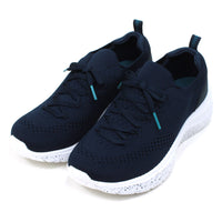 B Active navy blue slip on stretch fabric trainers with faux laces. Padded ankles. White speckled soles. Angled view.