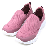 B Active pink slip on stretch fabric trainers. Padded ankles. White soles. Angled view.