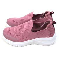 B Active pink slip on stretch fabric trainers. Padded ankles. White soles. Side view.