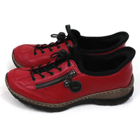 Rieker pull on red trainers with decorative zip. Elasticated black lace adjustment. Black rubber soles and black padded collars at ankles. Side view.