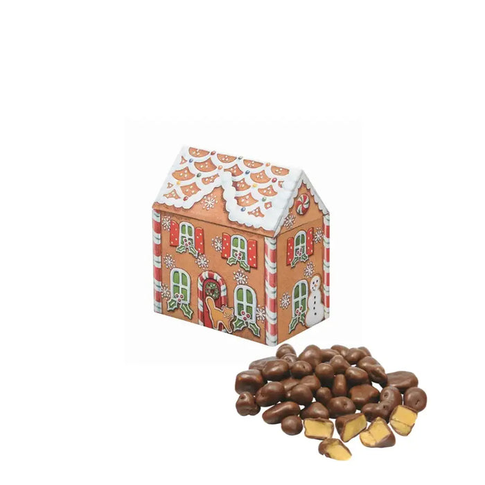 Gingerbread house-shaped candy box with decorative elements on a white background. Chocolate honeycomb crunch by the side.