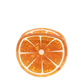 Hair clip in the shape of a slice of orange on a white background.