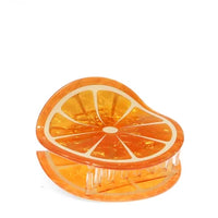 Orange slice-shaped hair dlip showing the hair claw teeth on a white background