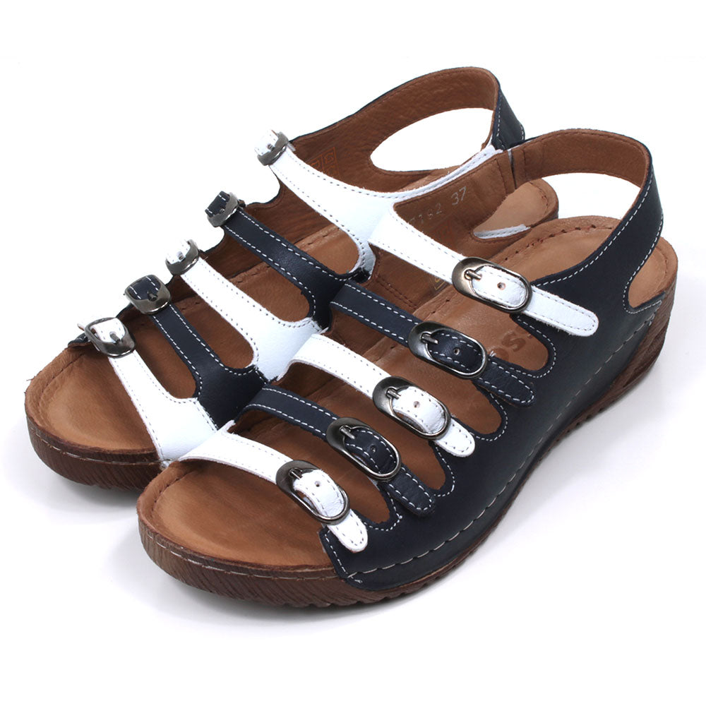 Adesso Astrid five buckled strap sandals in navy blue and white. Ankle strap. Low heels. Angled photograph.