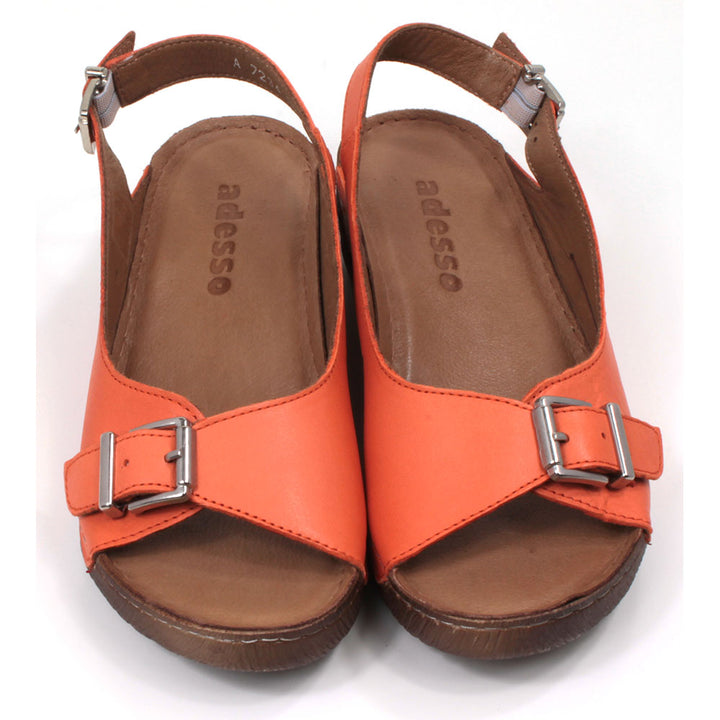 Adesso tangerine orange sandals with buckled strap over the toes and an adjustable strap around the heels. Low heeled. Front view.