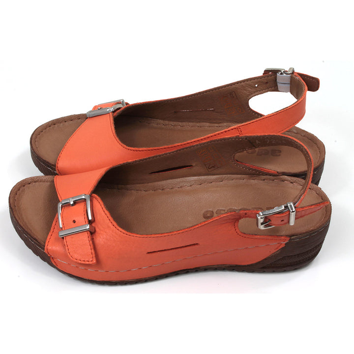 Adesso tangerine orange sandals with buckled strap over the toes and an adjustable strap around the heels. Low heeled. Side view.