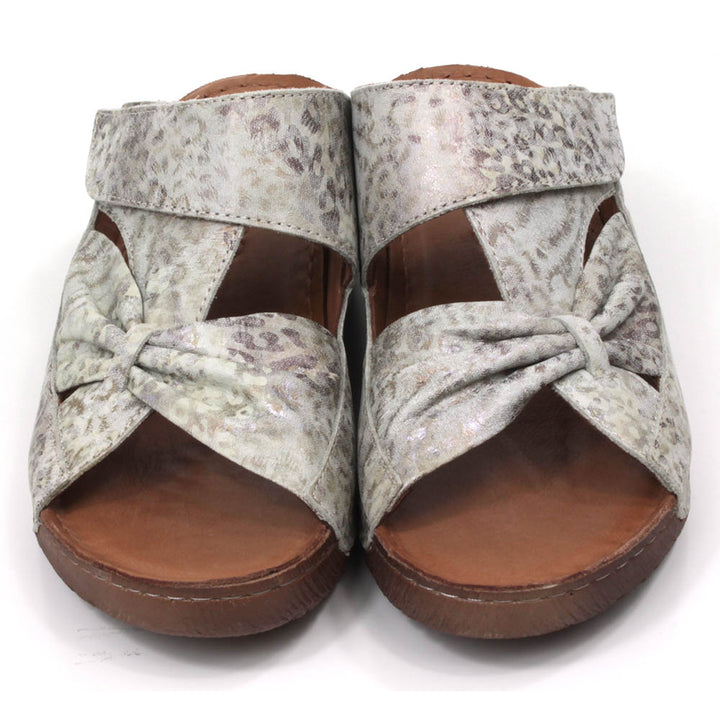 Adesso Lexi mule sandals. Low heels. Over the foot bow design in big cat print. Front view.