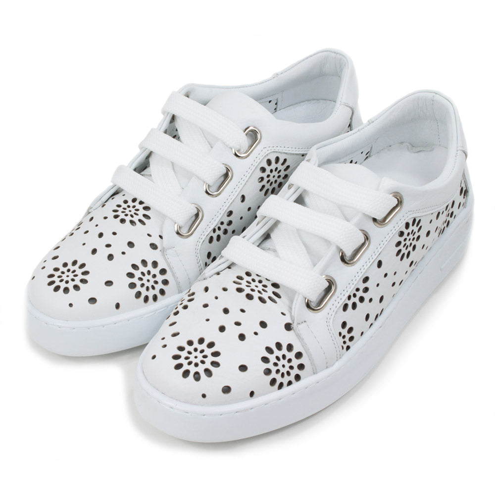 Adesso white training shoes with white rubber soles. Punched holes patterns over the entire shoes. Three holes while flat laces. Angled view.