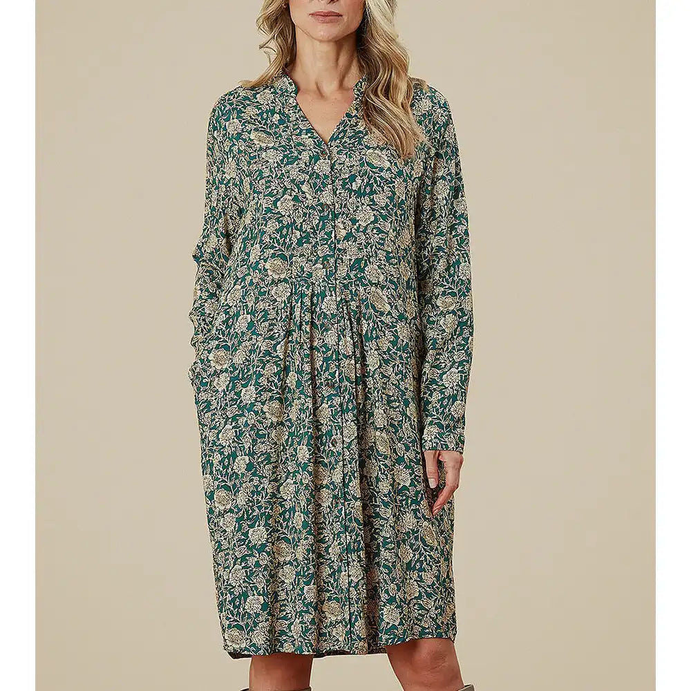 Woman wearing a floral dress against a beige background