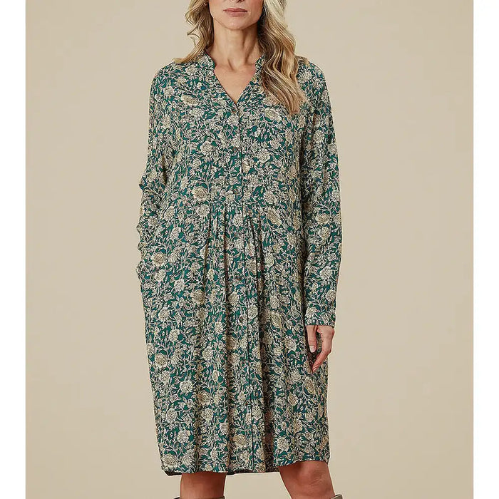 Woman wearing a floral dress against a beige background