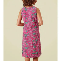 Woman wearing a pink floral dress on a beige background