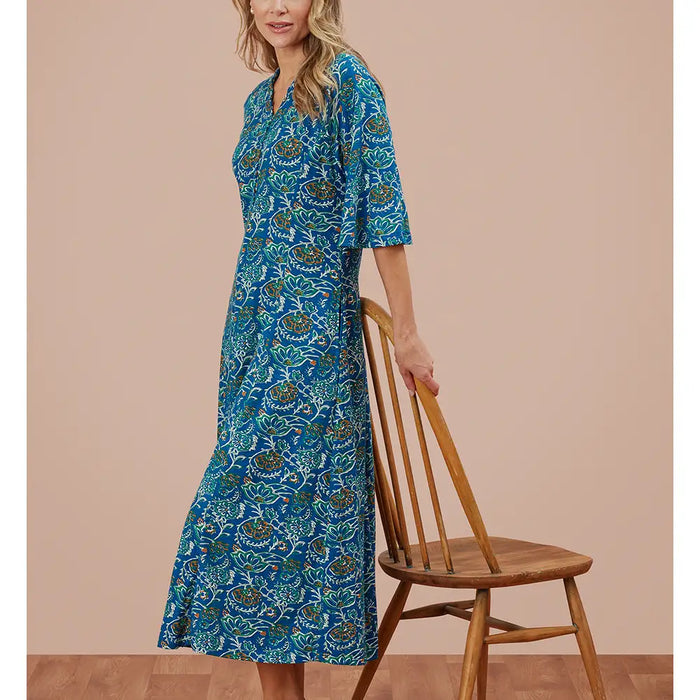 Blue patterned dress with elbow length bell sleeves and v neckline.