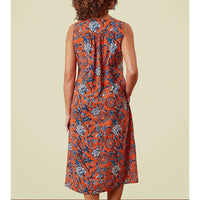 Sleeveless orange dress with blue floral print all over. Hip pockets and falling to the knee. 
