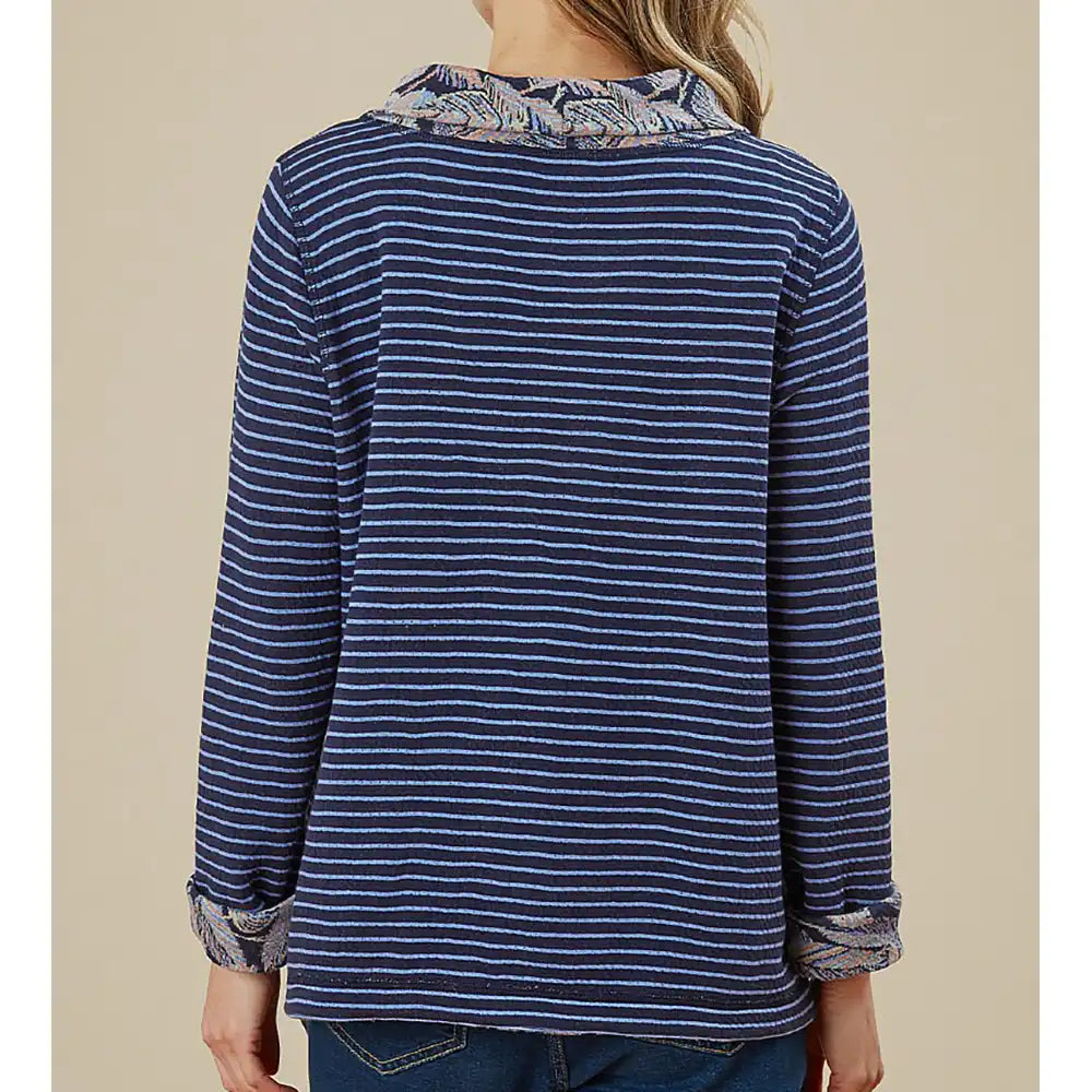 Blue striped shirt with patterned collar on a beige background