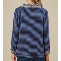 Blue striped shirt with patterned collar on a beige background