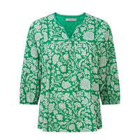 Green floral patterned blouse on a white background