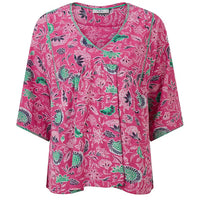 Pink blouse with green and black floral pattern on a white background