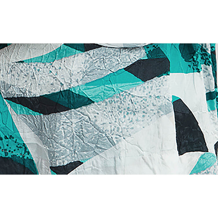 Geometric crushed fabric in a mixture of bright turquoise, black, white, beige and silver. 