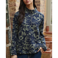 Person wearing a blue floral patterned pullover in an indoor setting.