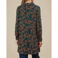 Long floral patterned dress worn by a person on a beige background