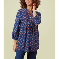 Three quarter length sleeves with pintuck detailing and buttons down the front. Blue base with multi coloured fans. 