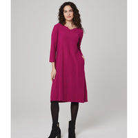 Knee length flared dress with three quarter length sleeves. A boat neckline with a wide V notch and hip pockets. 