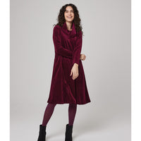 Flared knee length plum dress in a velvet finish. Long sleeves with round neckline and hip pockets.