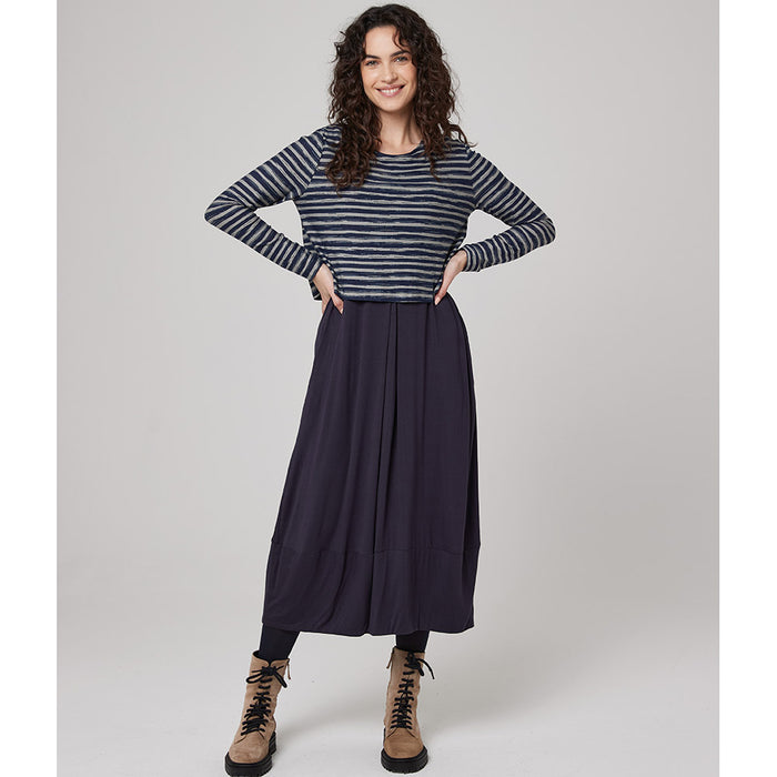 Front of dress, top is long sleeved, round neck line and has horizontal navy and silver stripes. Bottom is a A line navy skirt. 