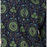 Close up of navy based top with a green mandala Indian inspired print featuring blue highlights. 