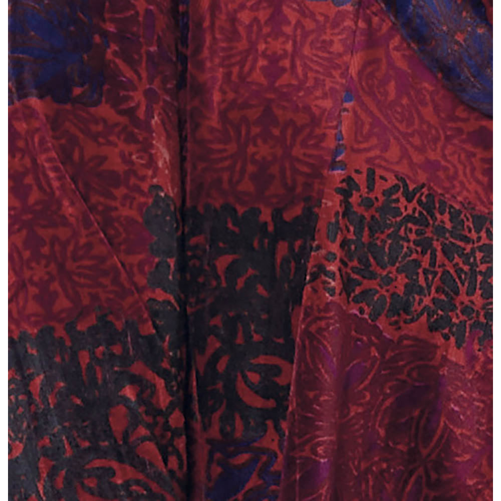 Close up of velvet fabric in a colour mixture of plum, orange, black and navy blue. 