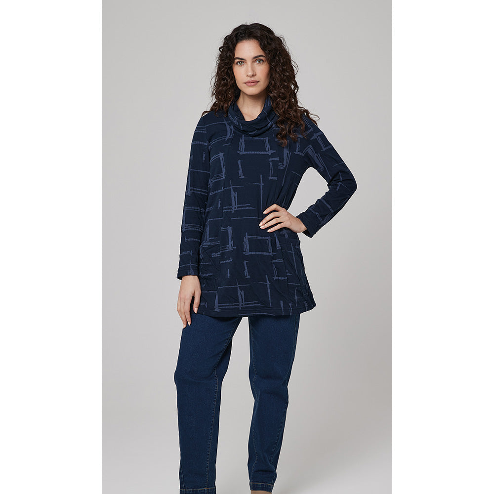 Front of navy blue based tunic that reached mid thigh. Long sleeves and patch pockets on the hips. Broken squared print in pale blue woth cowl neckline. 