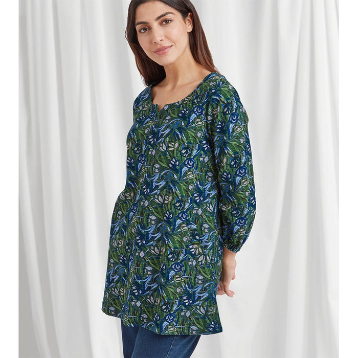 Blue and green floral crocus pint tunic that is mid thigh length, long cuffed sleeves and a boat neckline that has a v notch in the middle. 