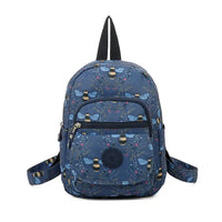 Fabric backpack with bees and foliage on blue background. Zipped pockets.