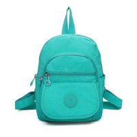 Small fabric backpack in turquoise. Zipped pockets.