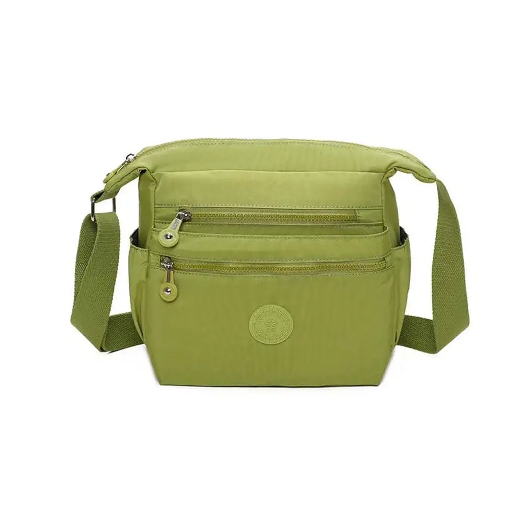 Green crossbody bag on a white background