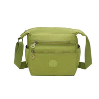 Green crossbody bag on a white background