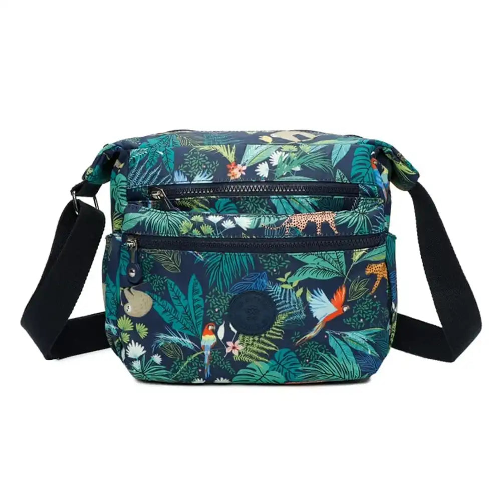 Shoulder bag with zipped pockets. Animals and jungle pattern on a navy blue background. Navy blue shoulder strap.