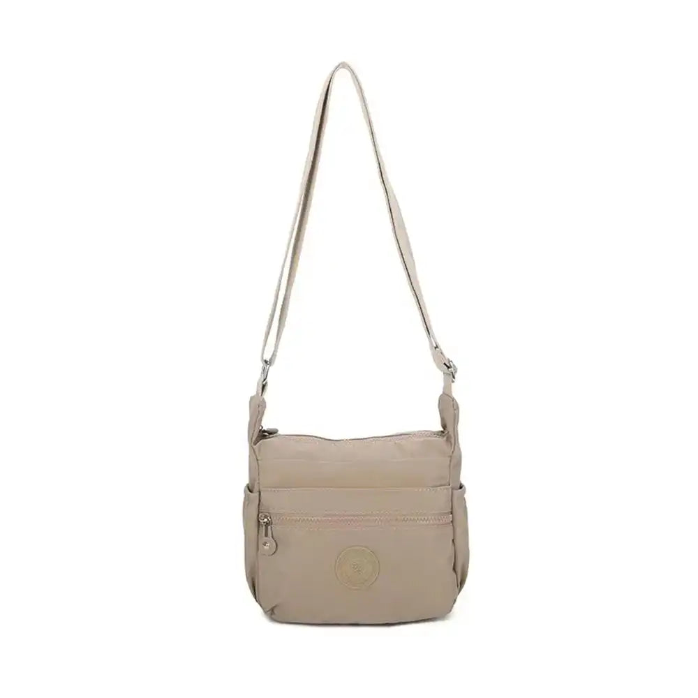 Plain beige messenger bag with fabric strap. Zipped pockets.