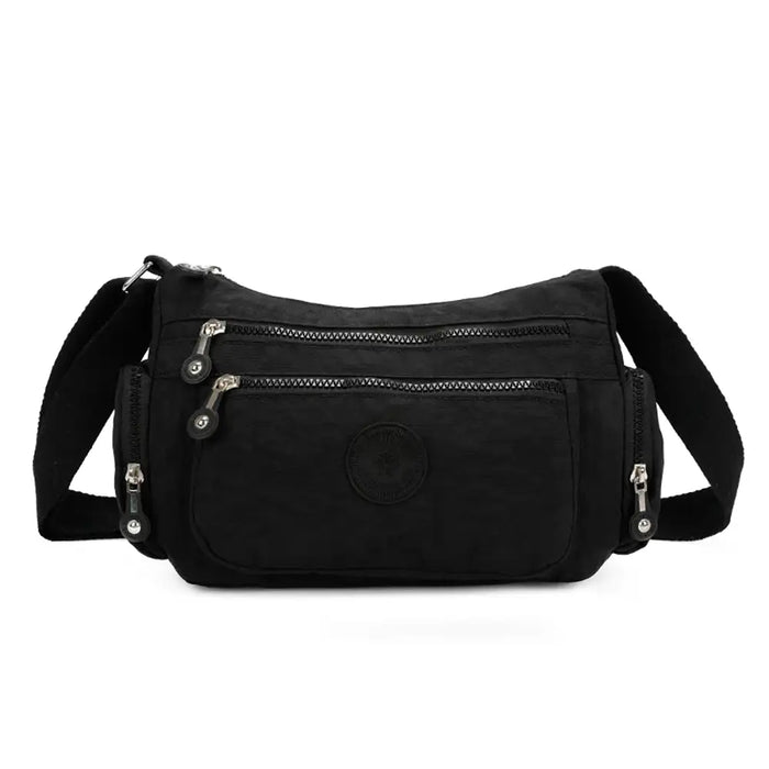 Black shoulder bag with multiple zippers on a white background