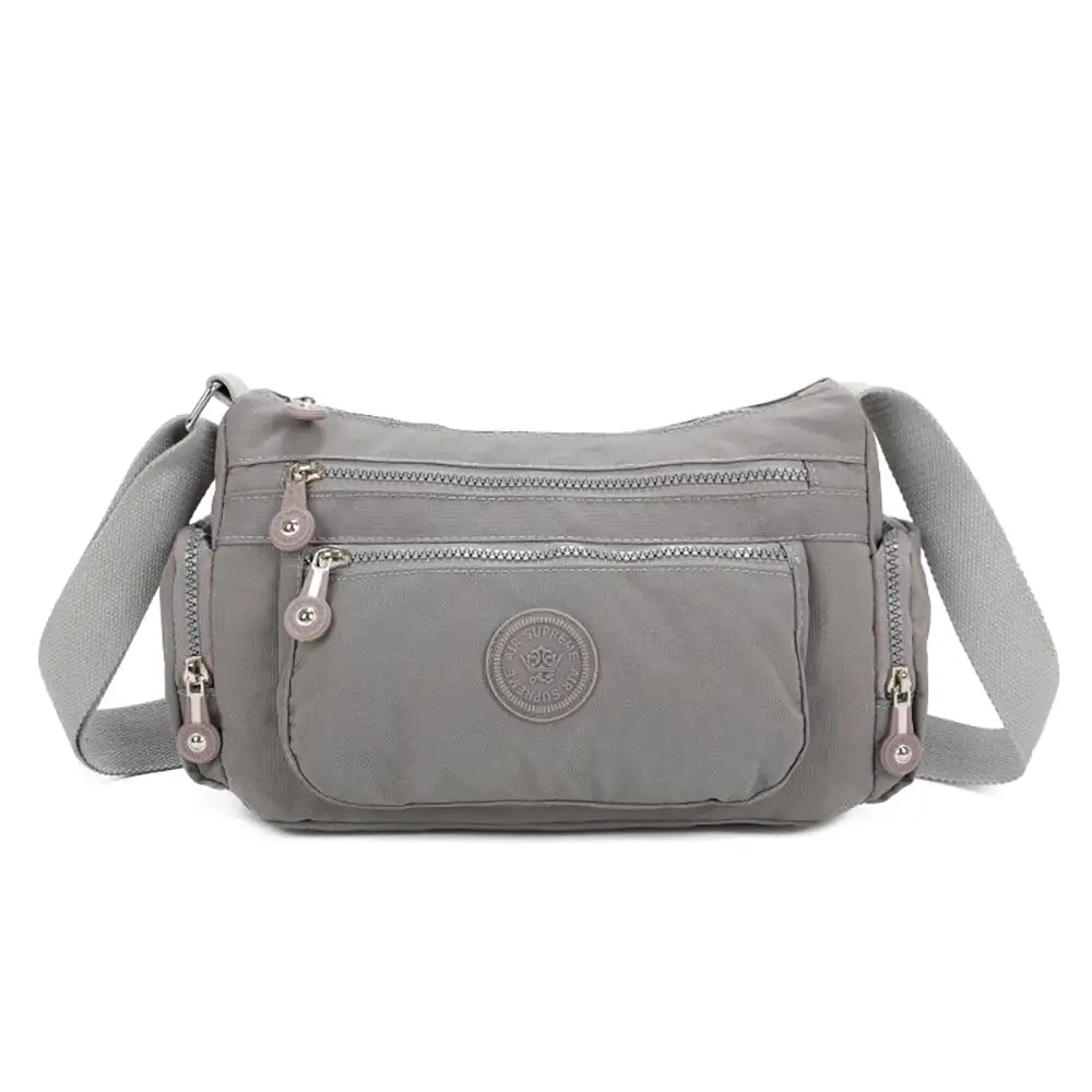 Gray shoulder bag with a visible brand logo on a white background
