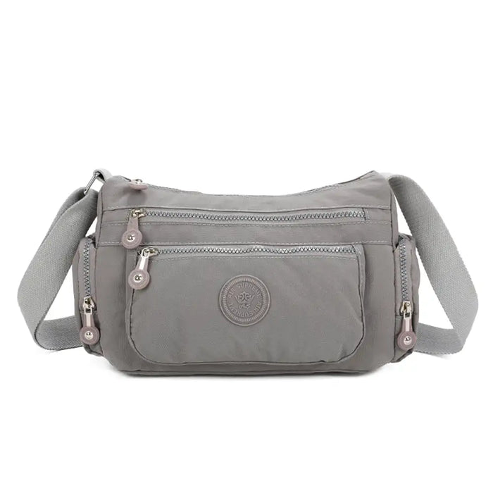 Gray shoulder bag with a visible brand logo on a white background