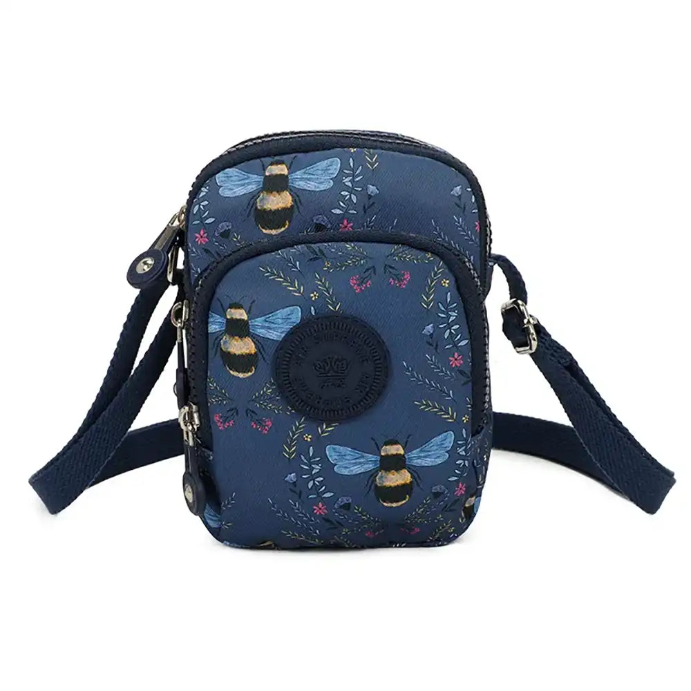 Dark blue shoulder bag with zipped pockets. Bees, flowers and grasses pattern. Dark blue straps.